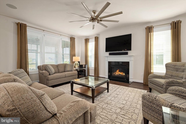 living room featuring lofted ceiling, hardwood / wood-style flooring, and ceiling fan