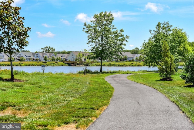 view of community featuring a lawn and a water view