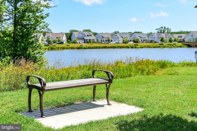 surrounding community featuring a water view and a yard