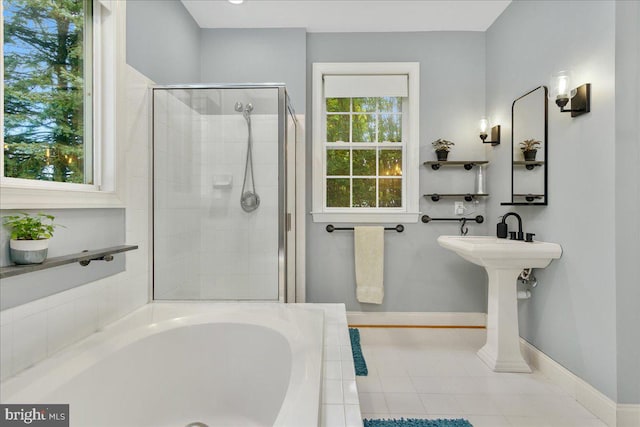 bathroom featuring tile patterned floors, a healthy amount of sunlight, and separate shower and tub