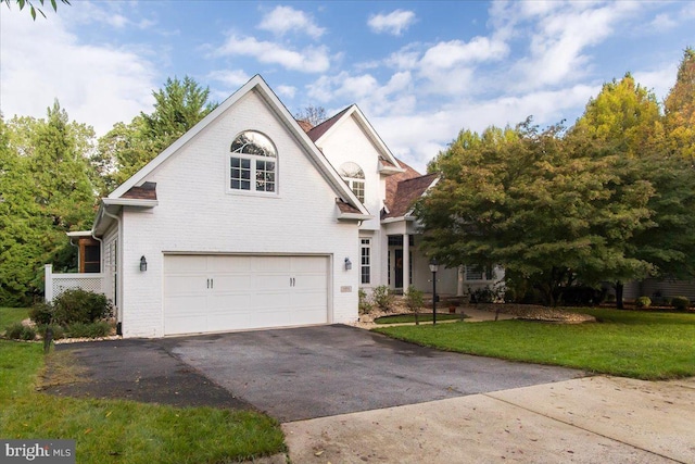 view of front property with a front yard and a garage