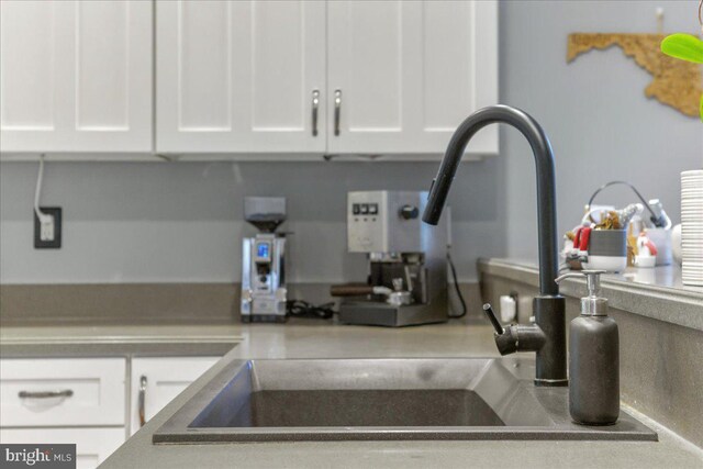 room details with white cabinetry and sink