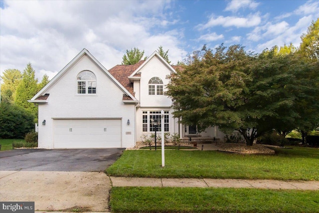 front of property with a garage and a front yard