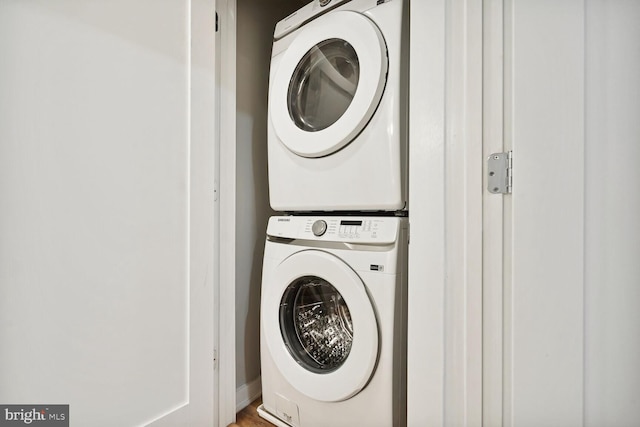 washroom with stacked washer / drying machine