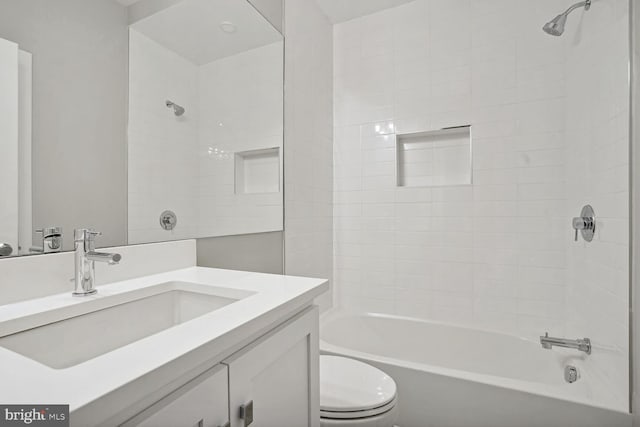 full bathroom with toilet, vanity, and tiled shower / bath combo