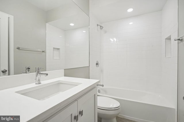 full bathroom with toilet, tiled shower / bath combo, and vanity