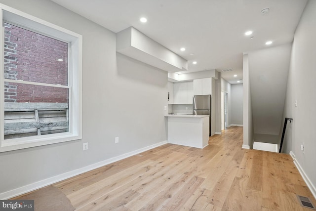 unfurnished living room with light hardwood / wood-style floors