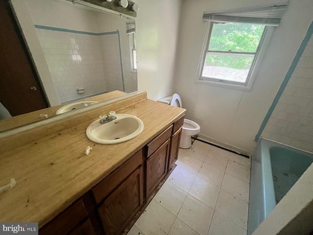 full bathroom featuring tile patterned flooring, tiled shower / bath combo, vanity, and toilet