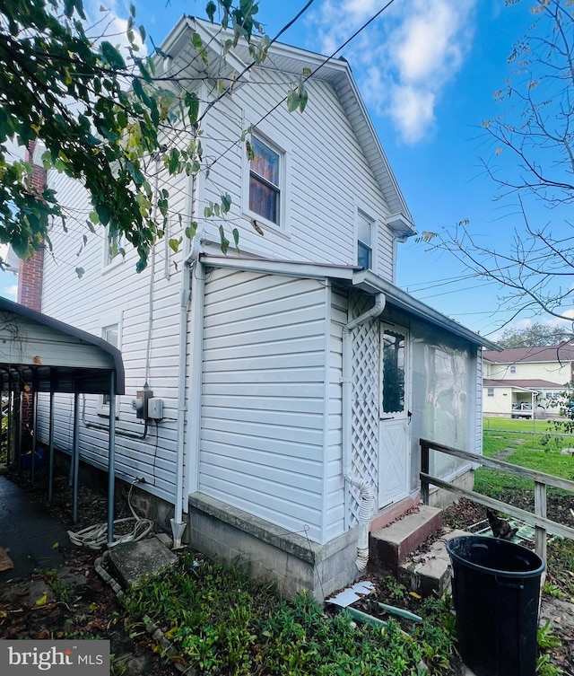 view of side of home featuring a carport