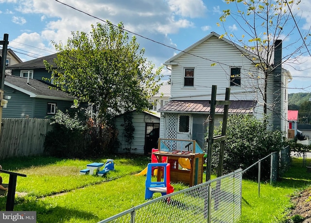 back of property featuring a lawn