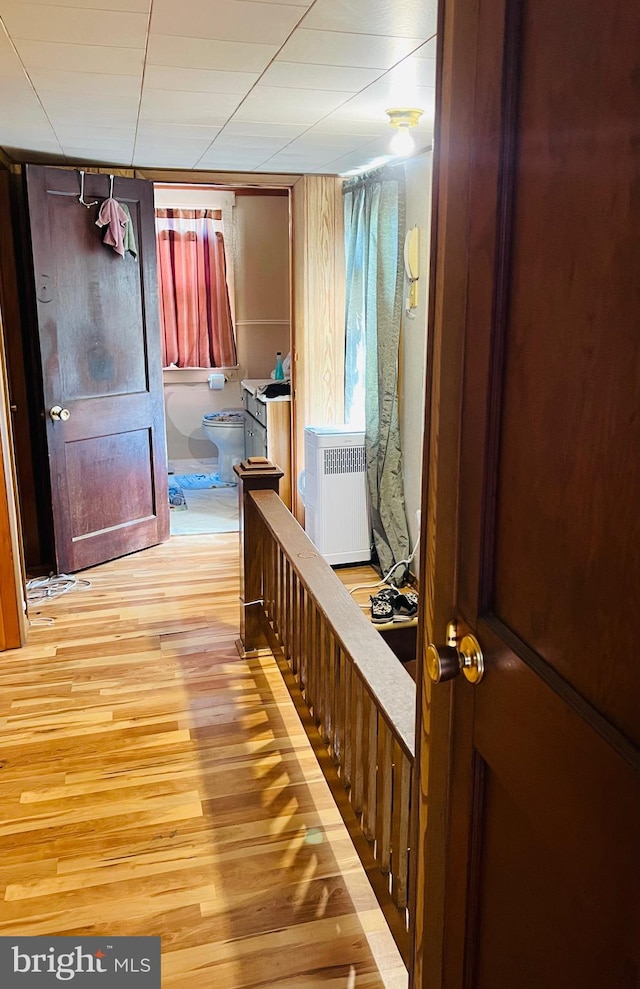 corridor featuring light hardwood / wood-style flooring and radiator heating unit