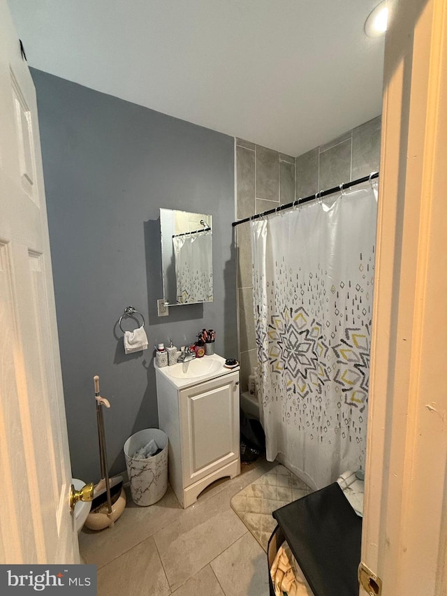 bathroom with vanity, shower / bath combo, and tile patterned floors