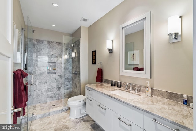 bathroom with an enclosed shower, vanity, and toilet