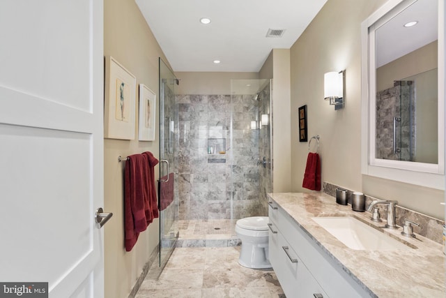 bathroom featuring walk in shower, vanity, and toilet