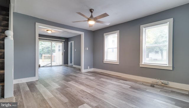 empty room featuring ceiling fan and light hardwood / wood-style flooring