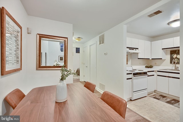 dining space featuring light hardwood / wood-style floors and sink