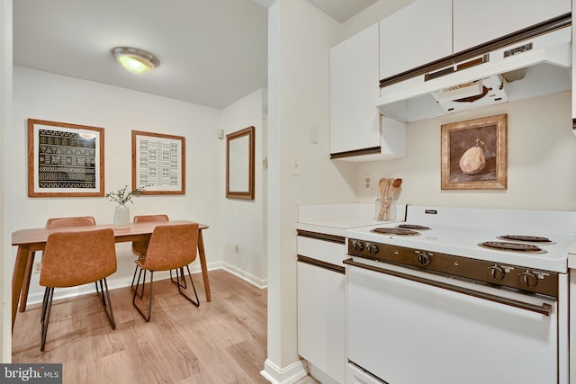 kitchen featuring white cabinets, white range with electric cooktop, and light wood-type flooring