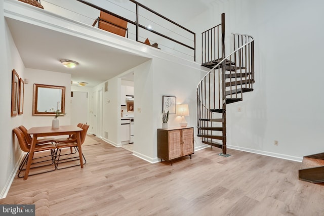 interior space featuring wood-type flooring and a high ceiling