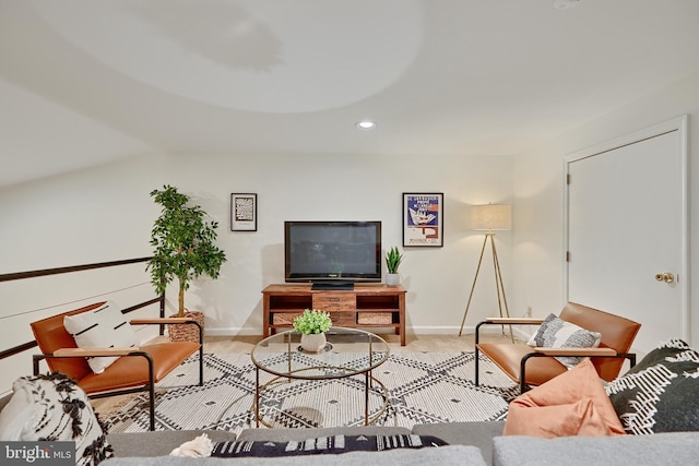 living room with lofted ceiling and light hardwood / wood-style floors