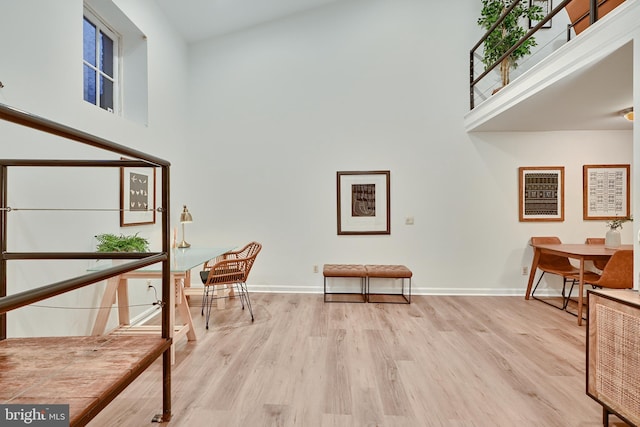 sitting room featuring light hardwood / wood-style floors and high vaulted ceiling