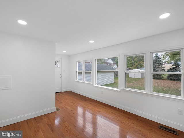 unfurnished room with a wealth of natural light and light wood-type flooring