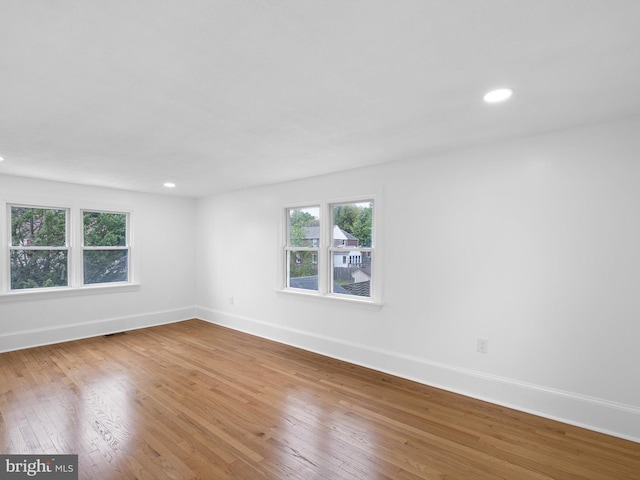 empty room with hardwood / wood-style floors