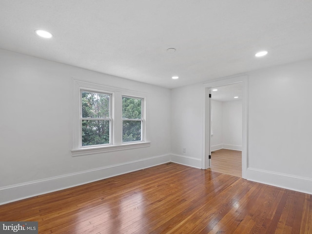 unfurnished room featuring hardwood / wood-style flooring