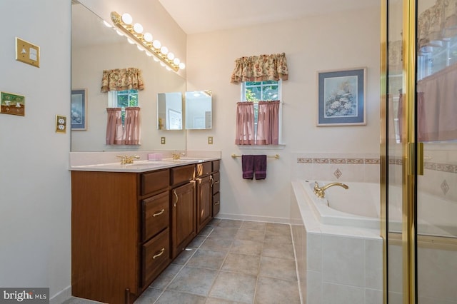 bathroom with separate shower and tub, vanity, and a wealth of natural light