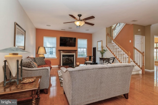 living room with ceiling fan and light hardwood / wood-style flooring