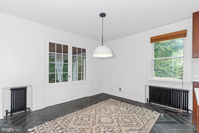 dining area featuring dark parquet flooring and radiator heating unit