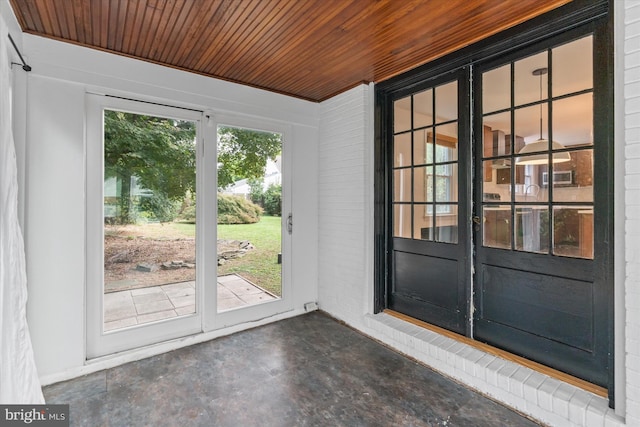 doorway to outside with wooden ceiling and a healthy amount of sunlight