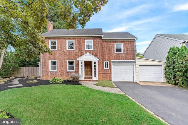 view of front of home featuring a front lawn and a garage