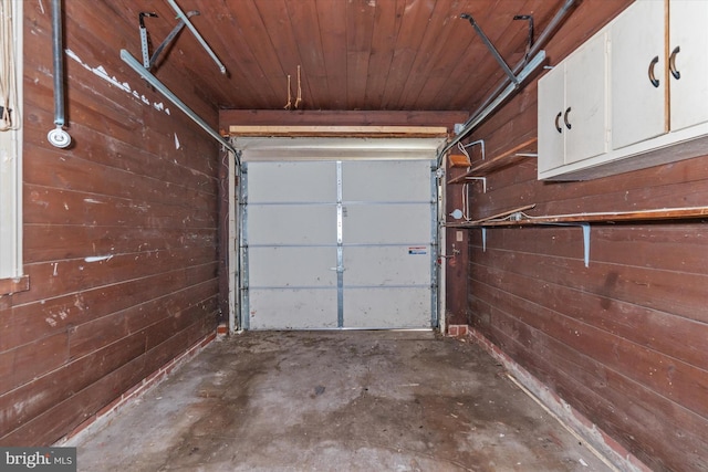 garage with wood ceiling and wood walls