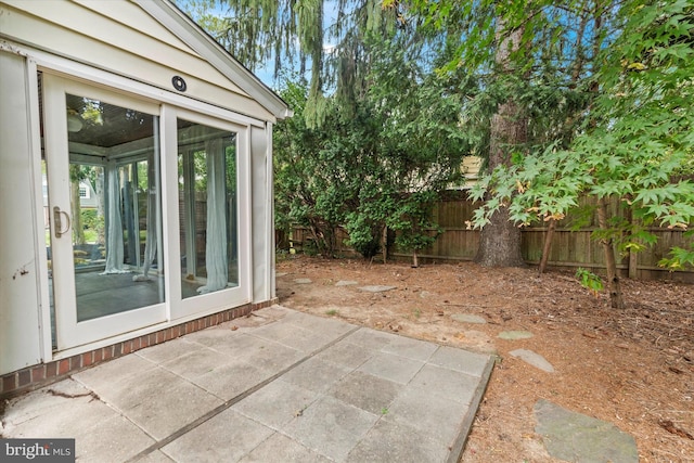 view of patio / terrace featuring a sunroom