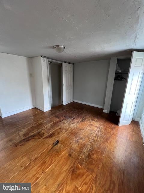 unfurnished bedroom with dark hardwood / wood-style floors