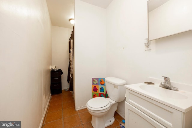 bathroom with tile patterned flooring, vanity, and toilet