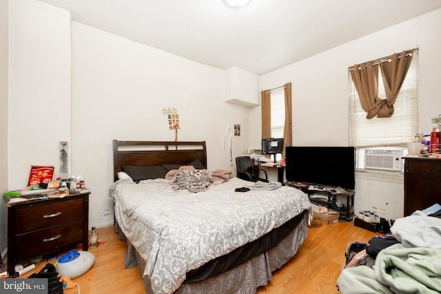 bedroom featuring light hardwood / wood-style floors and cooling unit