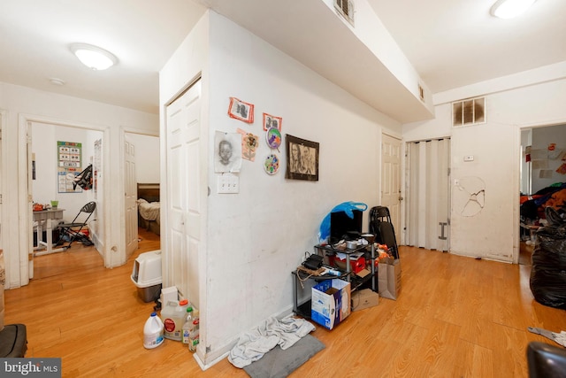 corridor with light hardwood / wood-style flooring