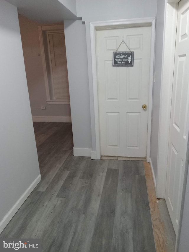 hallway with hardwood / wood-style floors