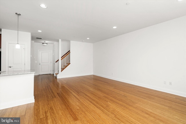 unfurnished living room with hardwood / wood-style flooring