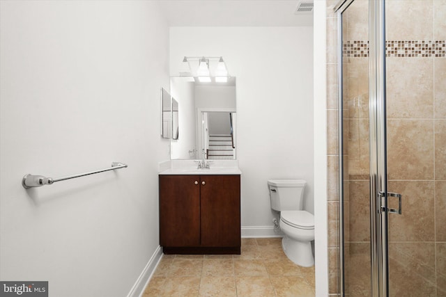 bathroom featuring walk in shower, vanity, toilet, and tile patterned floors