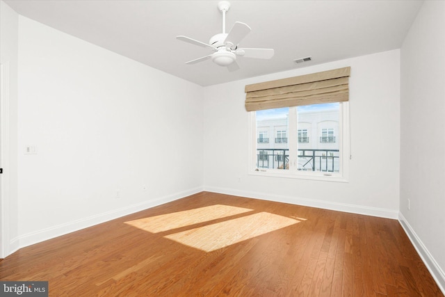 spare room with wood-type flooring and ceiling fan