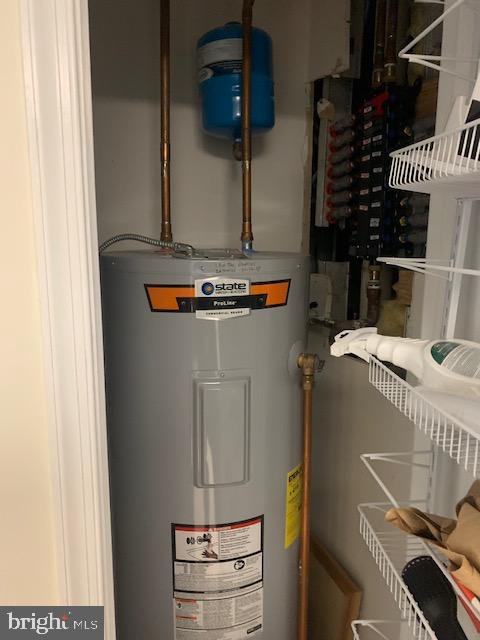 utility room with electric water heater