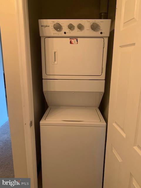 laundry area featuring stacked washer and clothes dryer