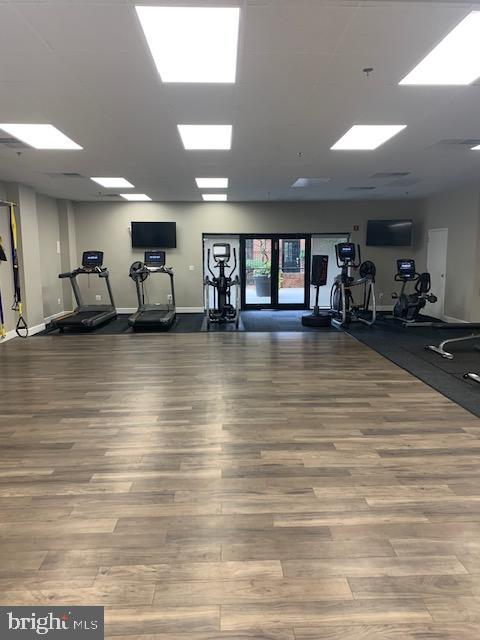 exercise room with wood-type flooring