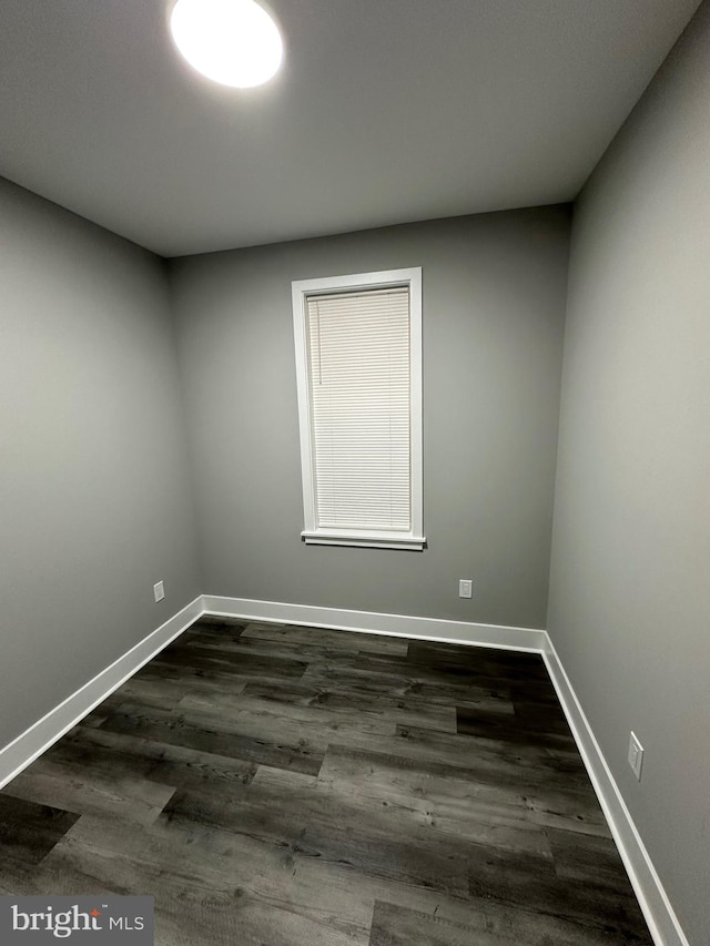 spare room with dark hardwood / wood-style floors