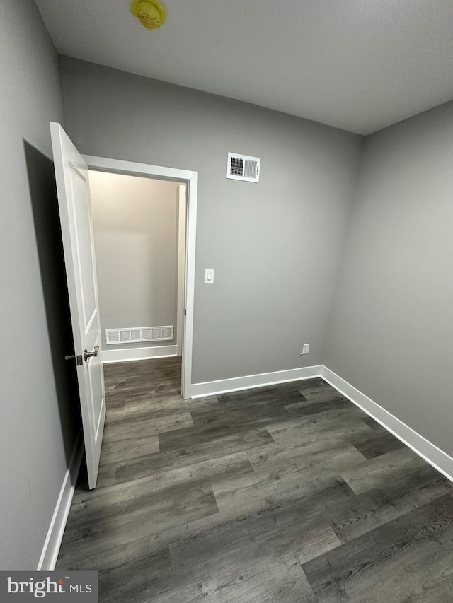 empty room featuring dark hardwood / wood-style floors