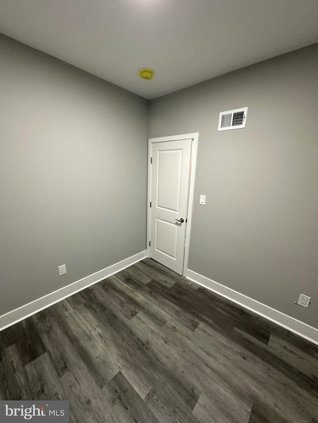 spare room featuring dark hardwood / wood-style flooring