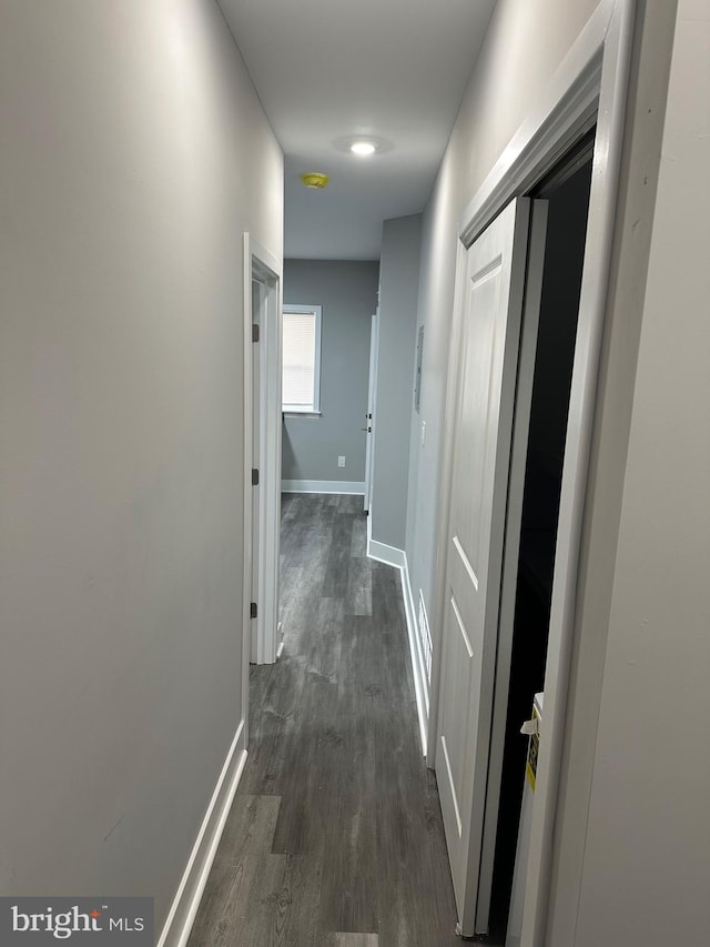 corridor featuring dark hardwood / wood-style floors