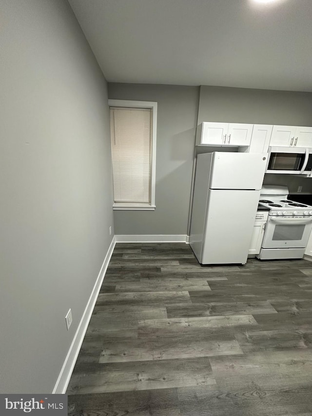 kitchen featuring white cabinets, white appliances, and dark hardwood / wood-style floors